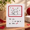 A square white greeting card with a red border and a simple line drawing of two embracing figures under a crescent moon, with the text 'For you, I will steal all the stars.