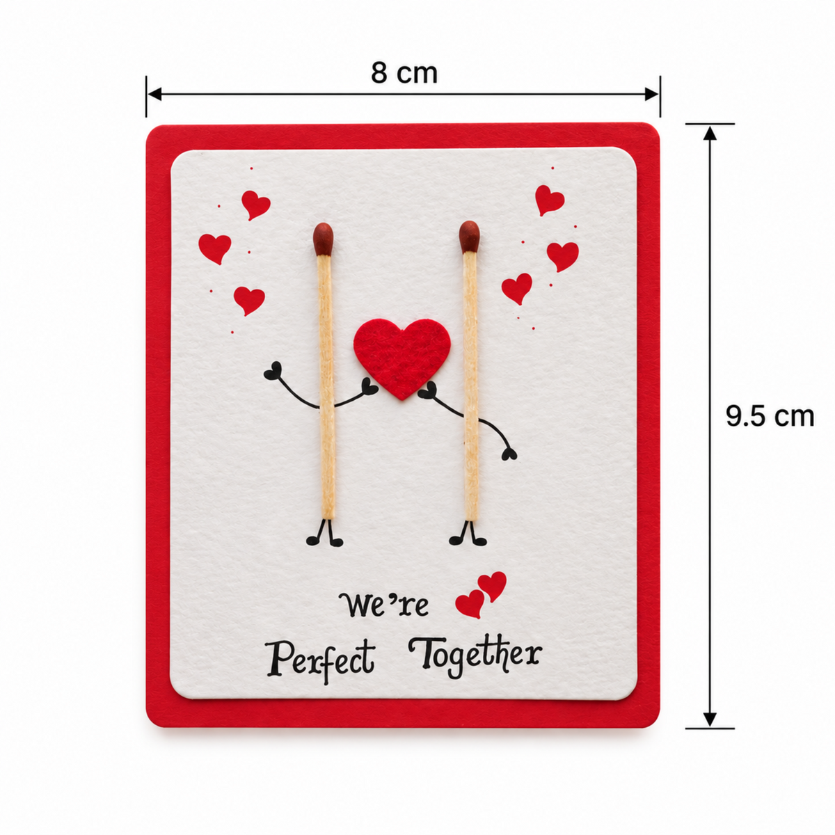 A square greeting card with a red border and a white center, featuring two matchsticks with black limbs holding a red felt heart, surrounded by small red hearts. The text reads 'We're Perfect Together.