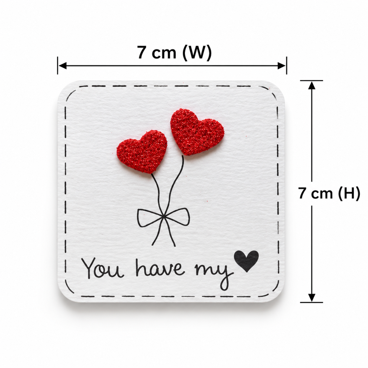 Square white card or plaque with a stitched border, featuring two red glittery heart balloons and the words 'You have my' with a small black heart. Black dimension lines indicate 7 cm width and 7 cm height on a white background.