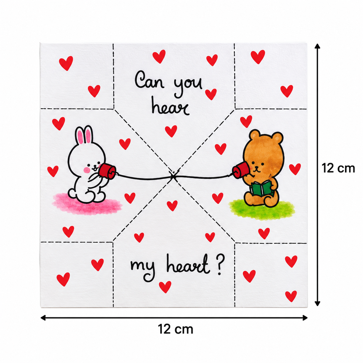 A square white paper craft template or card with printed fold lines, red heart motifs, a white bunny holding a red heart on the left, a brown bear holding a red heart on the right, and the text 'Can you hear my heart ?'. Black dimension arrows indicate 12 cm width and 12 cm height on a white background.
