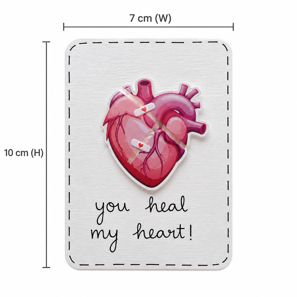 A rectangular white card or plaque with a stitched border, featuring a pink anatomical heart with bandages and the phrase 'you heal my heart!' in black script. Dimension lines indicate 7 cm width and 10 cm height.