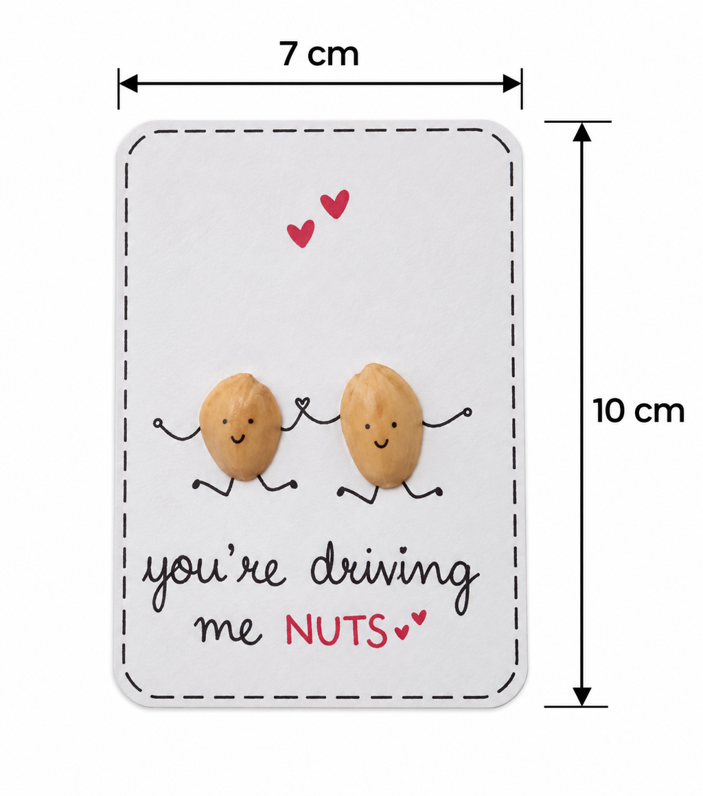 A rectangular novelty card or sign with rounded corners, shown with dimension arrows indicating 7 cm width and 10 cm height. The card has a white background with a dashed border, two small almond figures with faces and arms, two red hearts near the top, and the phrase 'you're driving me NUTS' in black and red script.